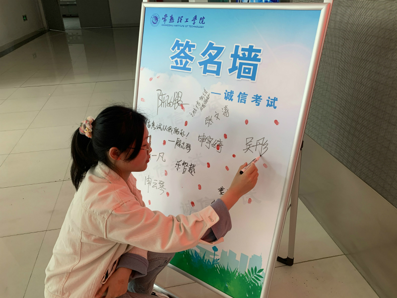 学生在诚信考试签名墙上签名.JPG